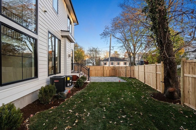 view of yard featuring a patio area and central air condition unit