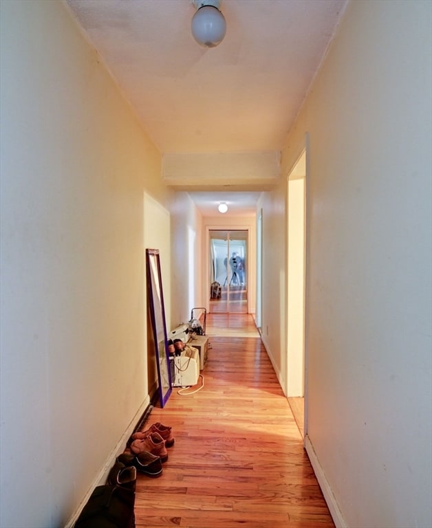 corridor with light hardwood / wood-style floors