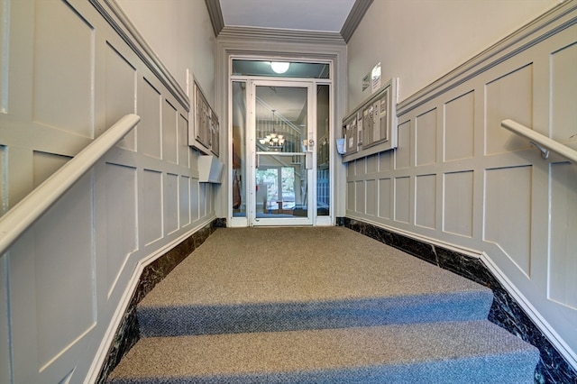 stairs with carpet and ornamental molding