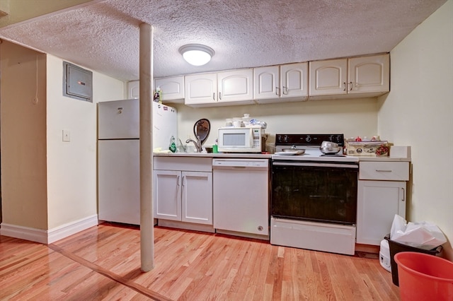 kitchen with white cabinetry, white appliances, a textured ceiling, light hardwood / wood-style flooring, and sink