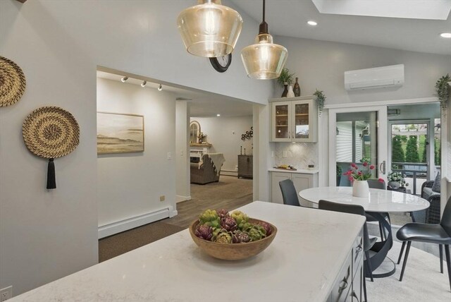 dining space with an AC wall unit, baseboard heating, recessed lighting, a skylight, and high vaulted ceiling
