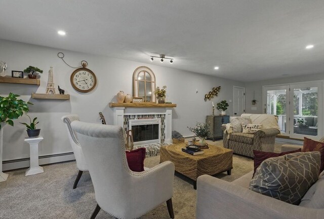 living room with a brick fireplace, recessed lighting, a baseboard heating unit, and carpet flooring