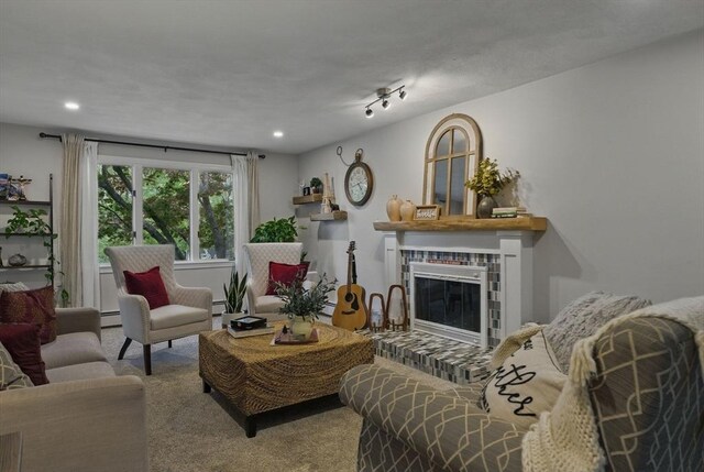 living area featuring carpet, a glass covered fireplace, recessed lighting, baseboard heating, and a baseboard heating unit