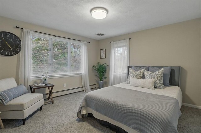 bedroom with carpet flooring, a baseboard radiator, and baseboards