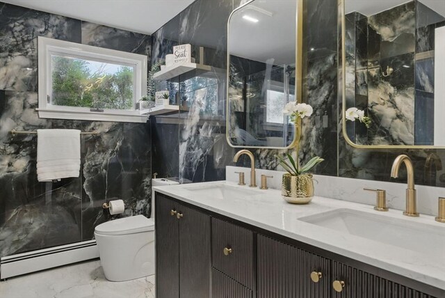 full bathroom with baseboard heating, marble tiled flooring, tile walls, toilet, and double vanity