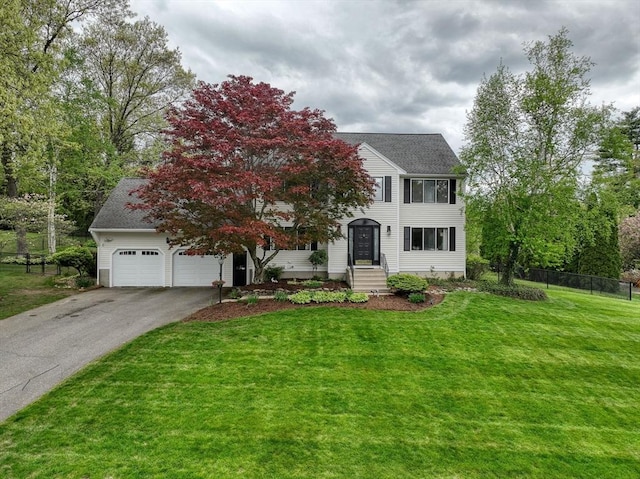 view of front of property with asphalt driveway and a garage