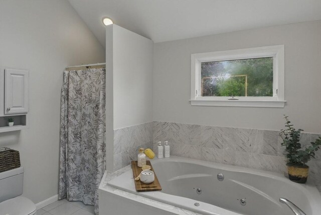 full bath featuring tile patterned floors, a whirlpool tub, and toilet