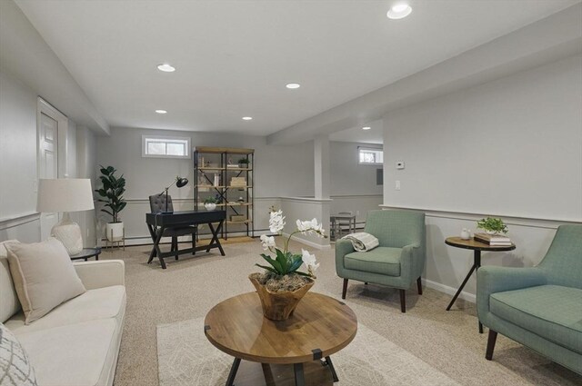 living area featuring recessed lighting and light carpet
