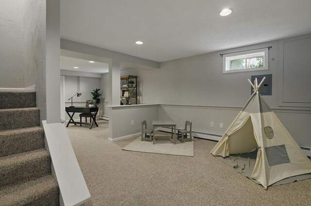 recreation room featuring a baseboard heating unit, recessed lighting, carpet floors, and electric panel