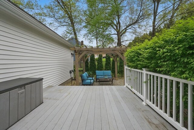 wooden deck featuring an outdoor living space and a pergola