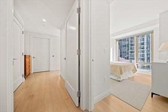 hallway with light hardwood / wood-style flooring