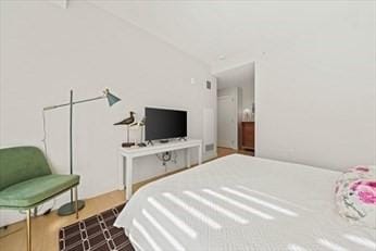 bedroom featuring hardwood / wood-style flooring and vaulted ceiling