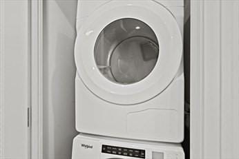 washroom with stacked washer and dryer