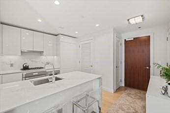 kitchen featuring sink, white cabinets, and gas cooktop