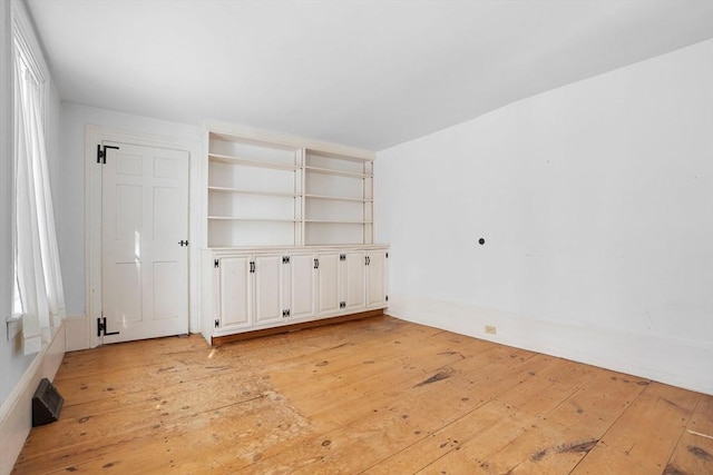 empty room featuring light wood-type flooring and visible vents