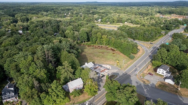 birds eye view of property with a wooded view