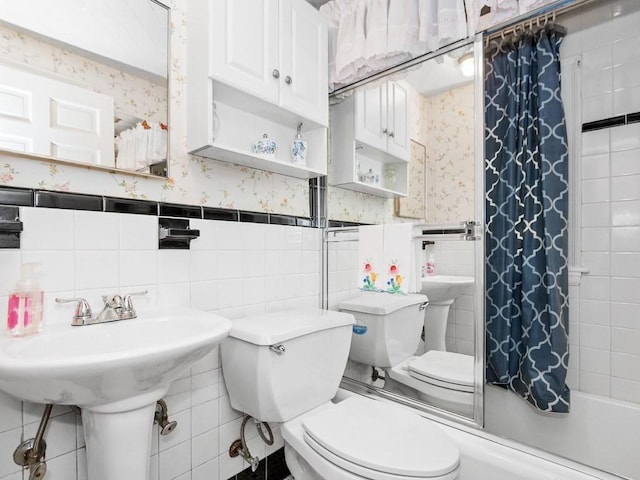 108 Edward Rd, Watertown, MA 02472 - full bathroom with wallpapered walls, toilet, a wainscoted wall, shower / tub combo with curtain, and tile walls