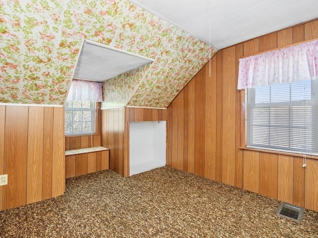 108 Edward Rd, Watertown, MA 02472 - additional living space with wood walls, vaulted ceiling, wallpapered walls, and carpet