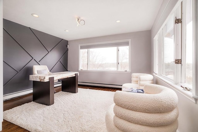 bedroom with multiple windows and a baseboard radiator