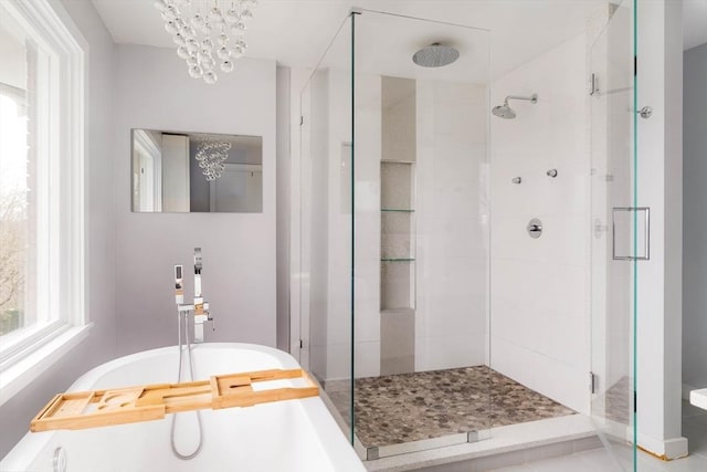 bathroom with independent shower and bath and a notable chandelier