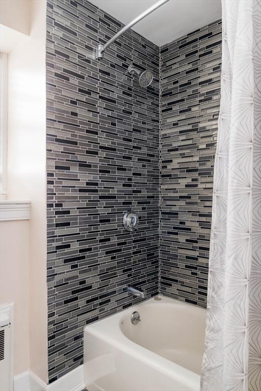 bathroom with shower / bathtub combination with curtain