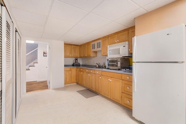 kitchen with sink, white appliances, and a paneled ceiling