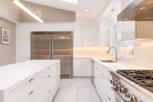 kitchen with white cabinetry, high end appliances, and sink