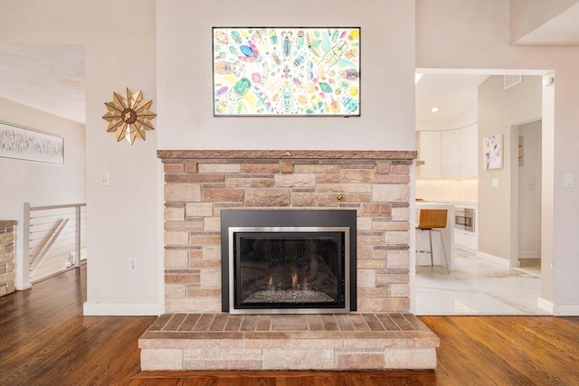 details featuring wood-type flooring and a stone fireplace