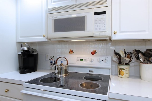 18 Periwinkle Ln, Mashpee, MA 02649 - kitchen with white appliances, white cabinets, backsplash, and light countertops