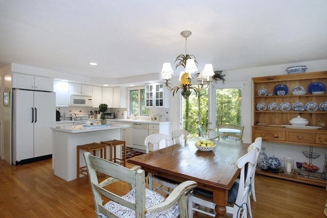 18 Periwinkle Ln, Mashpee, MA 02649 - dining space featuring a chandelier, wood finished floors, and recessed lighting