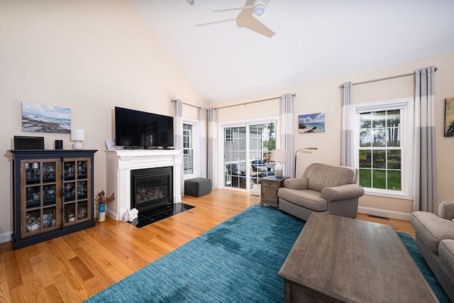 194 Crownshield Ave Unit 194, Uxbridge, MA 01569 - living room with ceiling fan, wood finished floors, a fireplace with flush hearth, and high vaulted ceiling