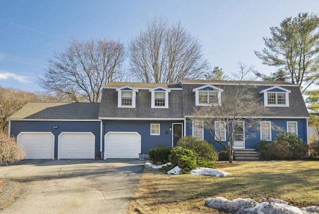 view of front of house featuring a front lawn, driveway, an attached garage, and roof with shingles