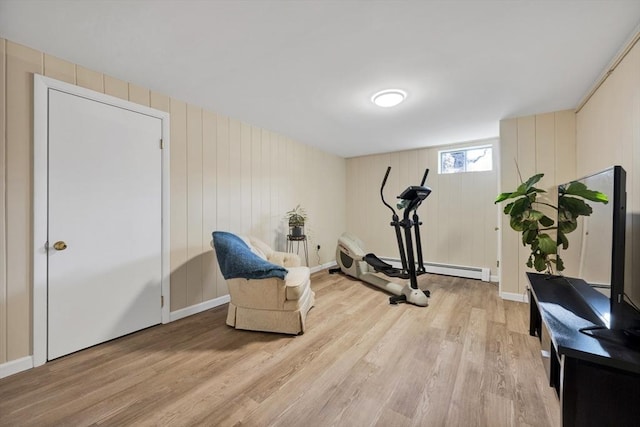 exercise room featuring light wood-style floors