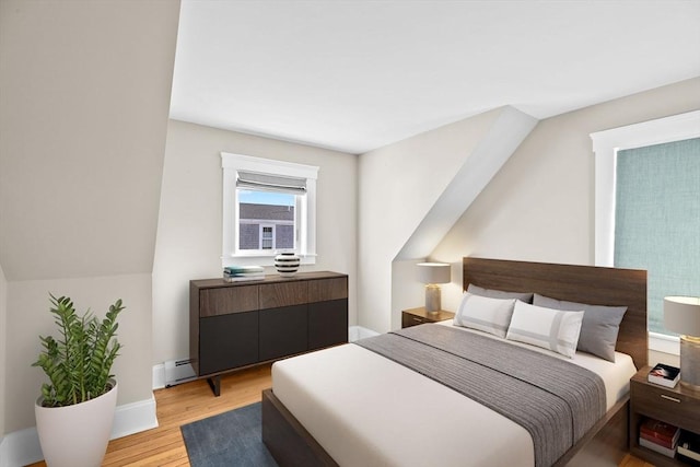 bedroom featuring a baseboard radiator and light hardwood / wood-style floors