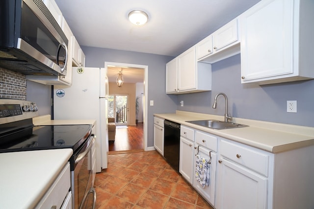 kitchen featuring sink, white cabinets, light wood-type flooring, appliances with stainless steel finishes, and tasteful backsplash