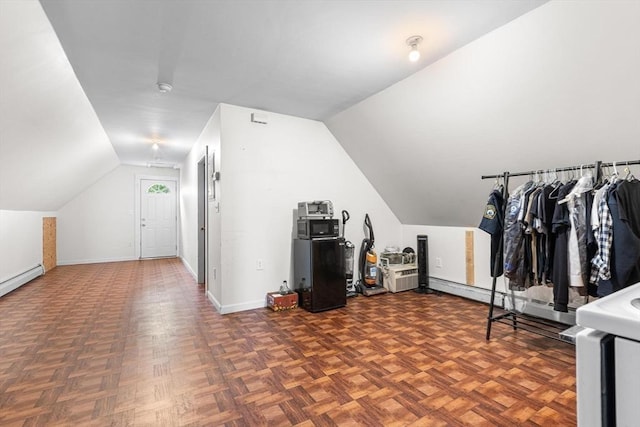 bonus room featuring vaulted ceiling and baseboards