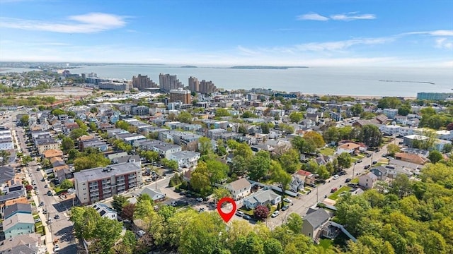 aerial view of property's location with a nearby body of water and nearby urban area