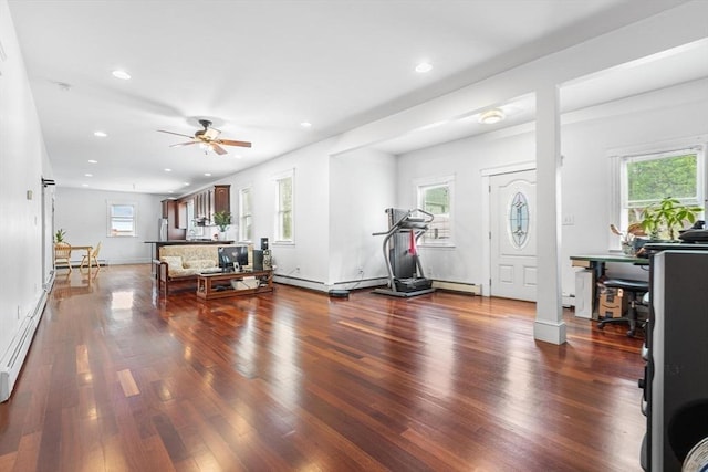 exercise room with healthy amount of natural light, a ceiling fan, recessed lighting, wood finished floors, and a baseboard radiator