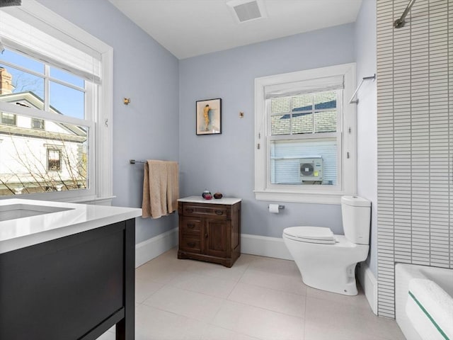 full bath featuring visible vents, vanity, toilet, baseboards, and a bathing tub