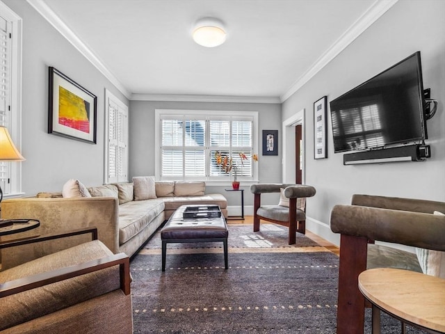living room featuring crown molding, baseboards, and wood finished floors