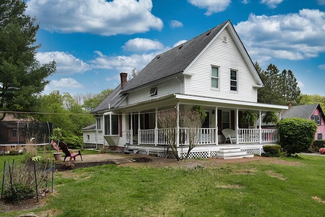 735 Hildreth St, Dracut, MA 01826 - rear view of property featuring a trampoline, roof with shingles, a porch, and a lawn