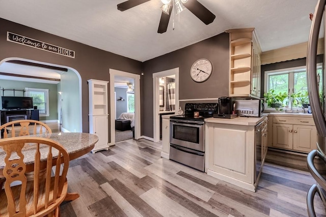 735 Hildreth St, Dracut, MA 01826 - kitchen featuring stainless steel electric range oven, ceiling fan, light countertops, and light wood-style floors