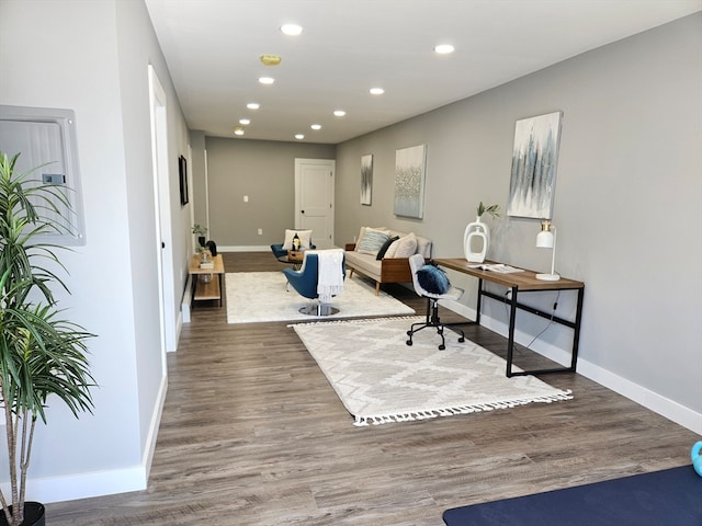 home office with dark hardwood / wood-style flooring