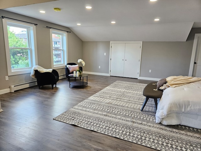 bedroom with lofted ceiling, baseboard heating, and dark hardwood / wood-style floors