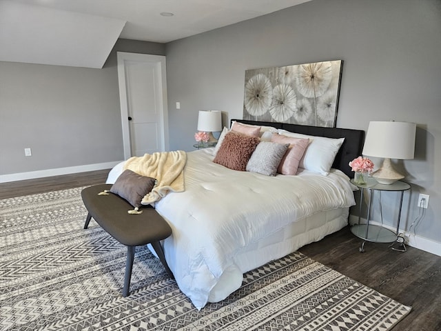 bedroom with dark hardwood / wood-style floors