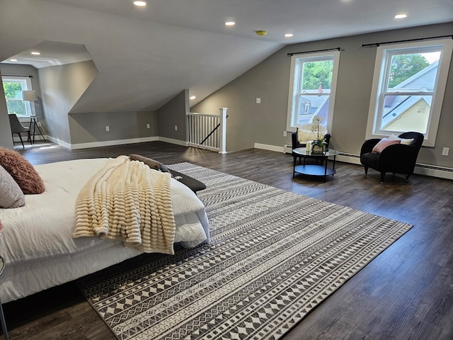 bedroom featuring dark wood-type flooring, multiple windows, a baseboard heating unit, and lofted ceiling