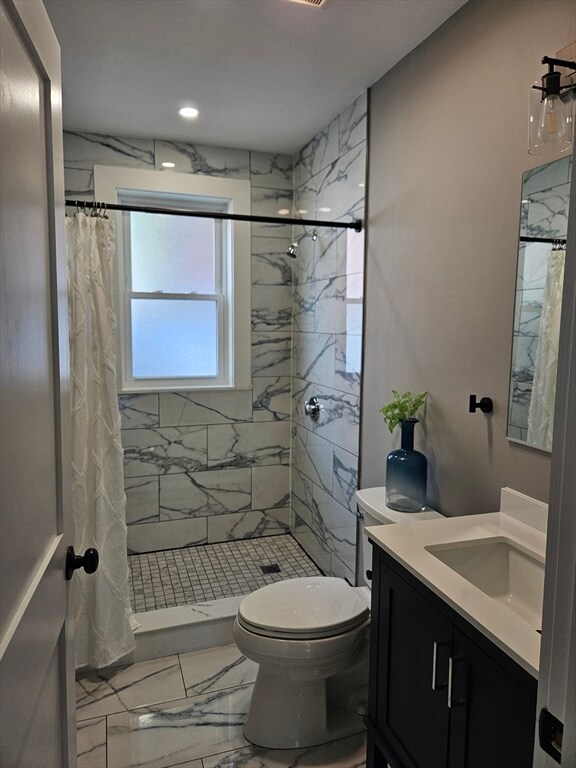 bathroom featuring toilet, a shower with curtain, and vanity