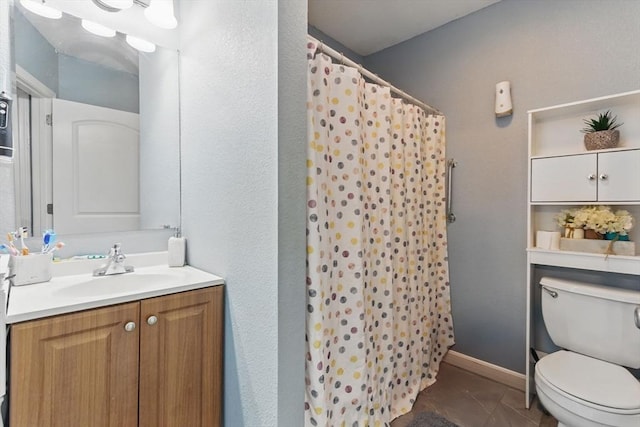 bathroom featuring toilet, a shower with curtain, and vanity