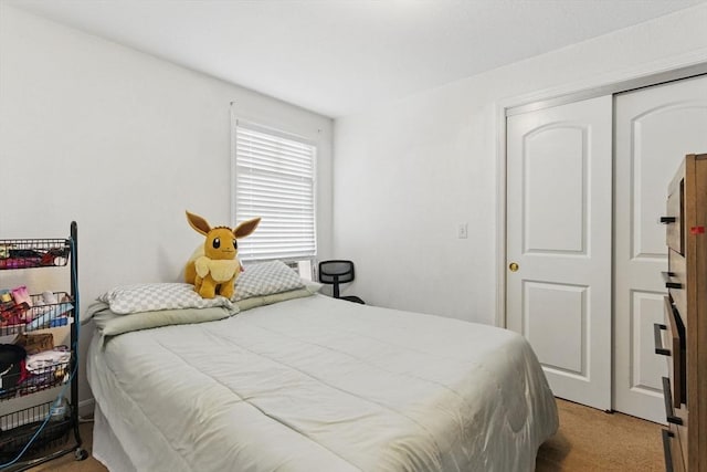 bedroom with carpet and a closet