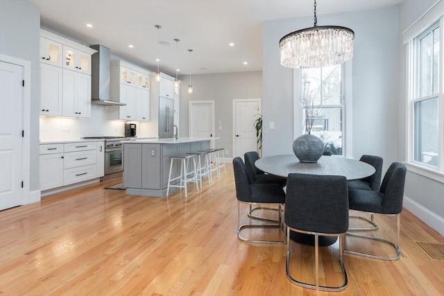 dining area featuring a chandelier and light wood-type flooring